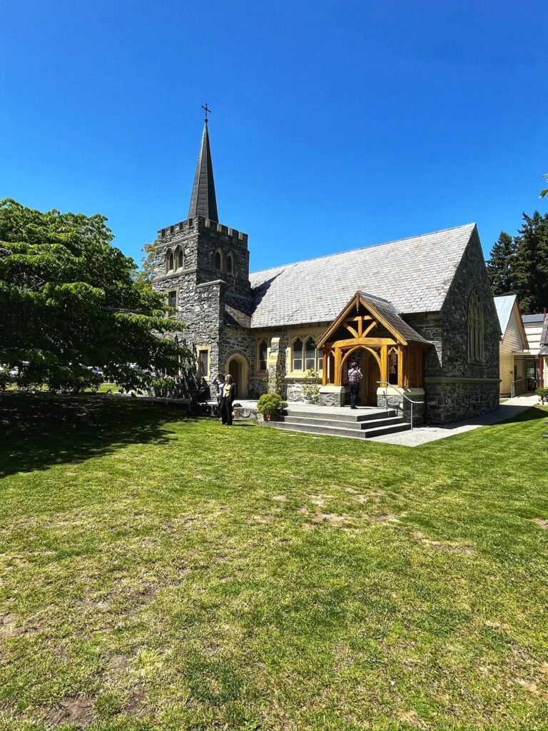 Photo d’une église à Queenstown entourée d’arbres 